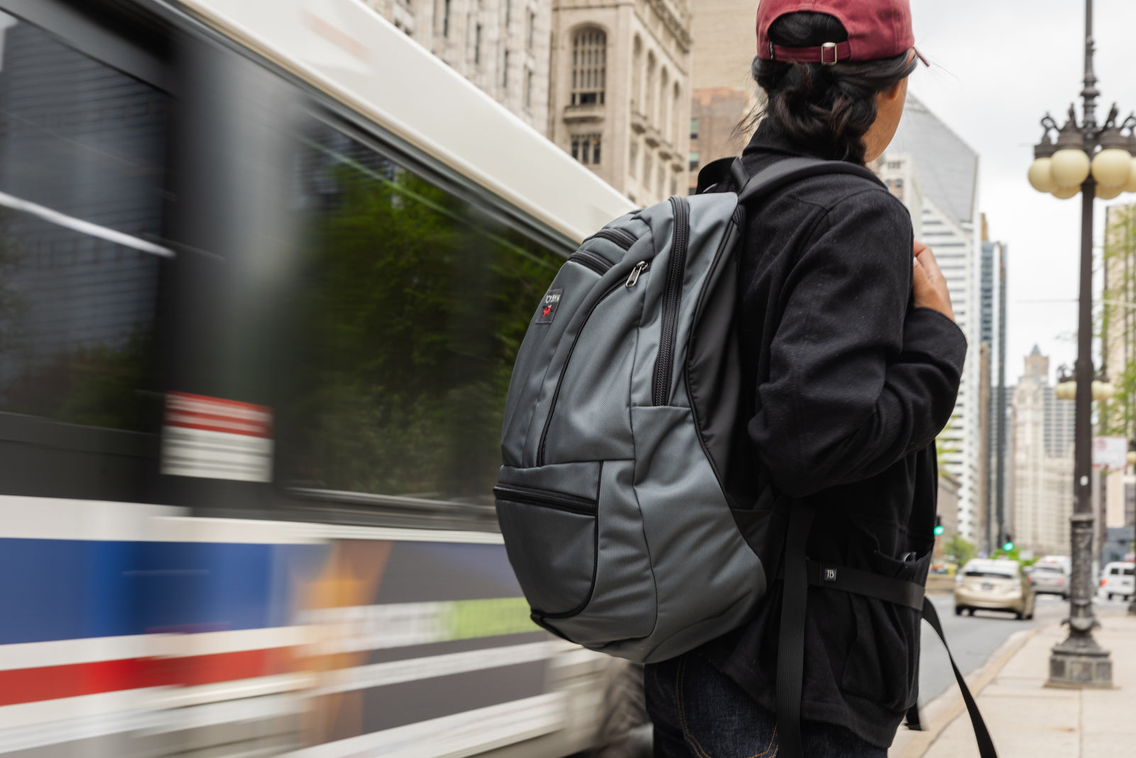 Person standing in downtown Seattle wearing a Nebulous Grey Synapse 25.