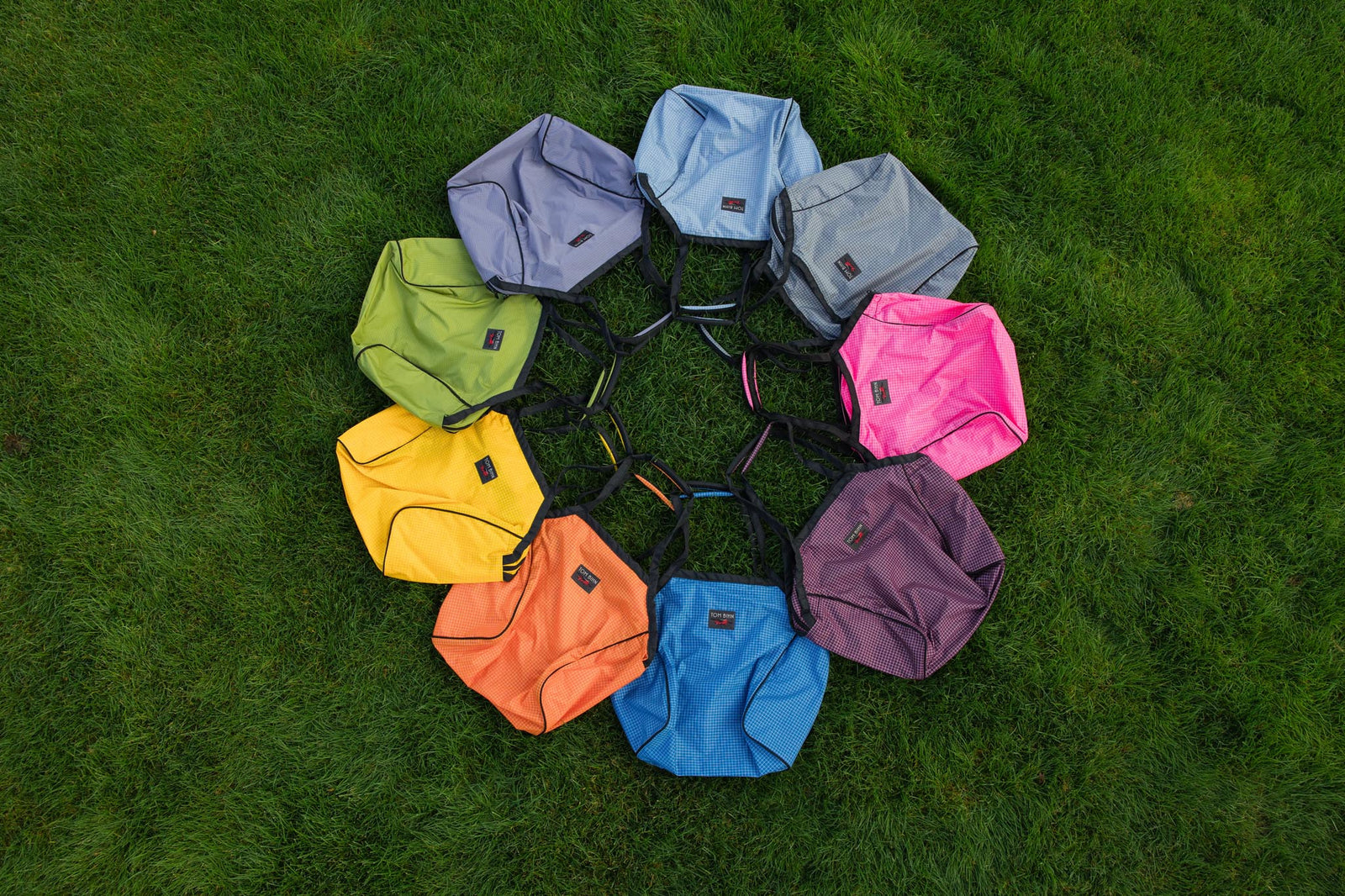 visible lifestyle^^All the Large Zip-Top Shop Bags in a circle on grass.
