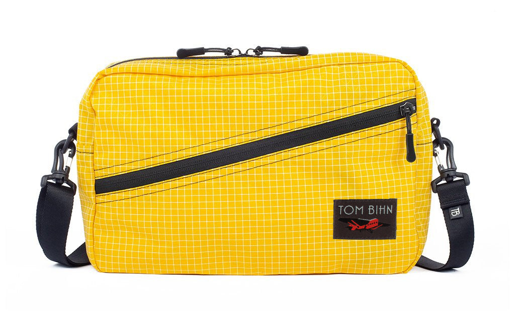 visible variant TB0921-OD^^A Packing Cube Shoulder Bag in Solaris (yellow with white grid) 200 Halcyon with a 1-inch shoulder strap attached.