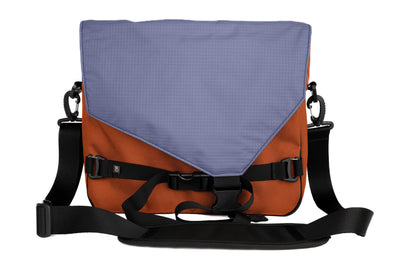 visible variant TB0204-TKDL^^The Maker's Bag in Burnt Orange Ballistic with a Dusk (bluish-purple with light bluish-purple grid) 210 Cerylon interior.