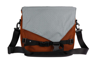 visible variant TB0204-TKND^^The Maker's Bag in Burnt Orange 525 Ballistic with a Northwest Sky (light grey with white grid) 200 Halcyon interior.