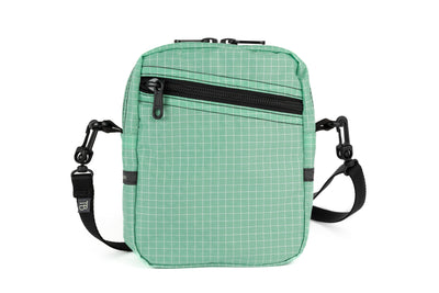 visible variant TB0416-GDGE^^An Everyday Cubelet in Seafoam Halcyon (green with a white grid) with a front zipper.