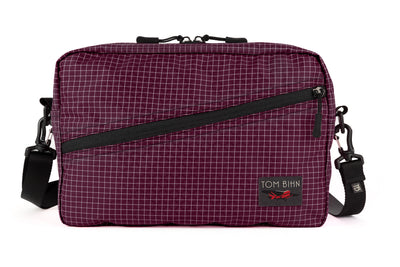 visible variant TB0921-5D^^A Packing Cube Shoulder Bag in Acai (dark purple with white grid) 200 Halcyon with a shoulder strap attached