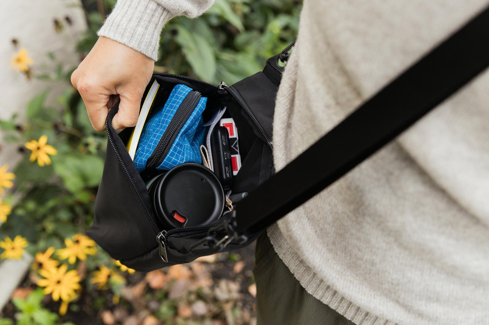 visible lifestyle^^Rogue sacoche with a phone, playing cards, vertical packing cubelet, notepad, and water bottle inside.