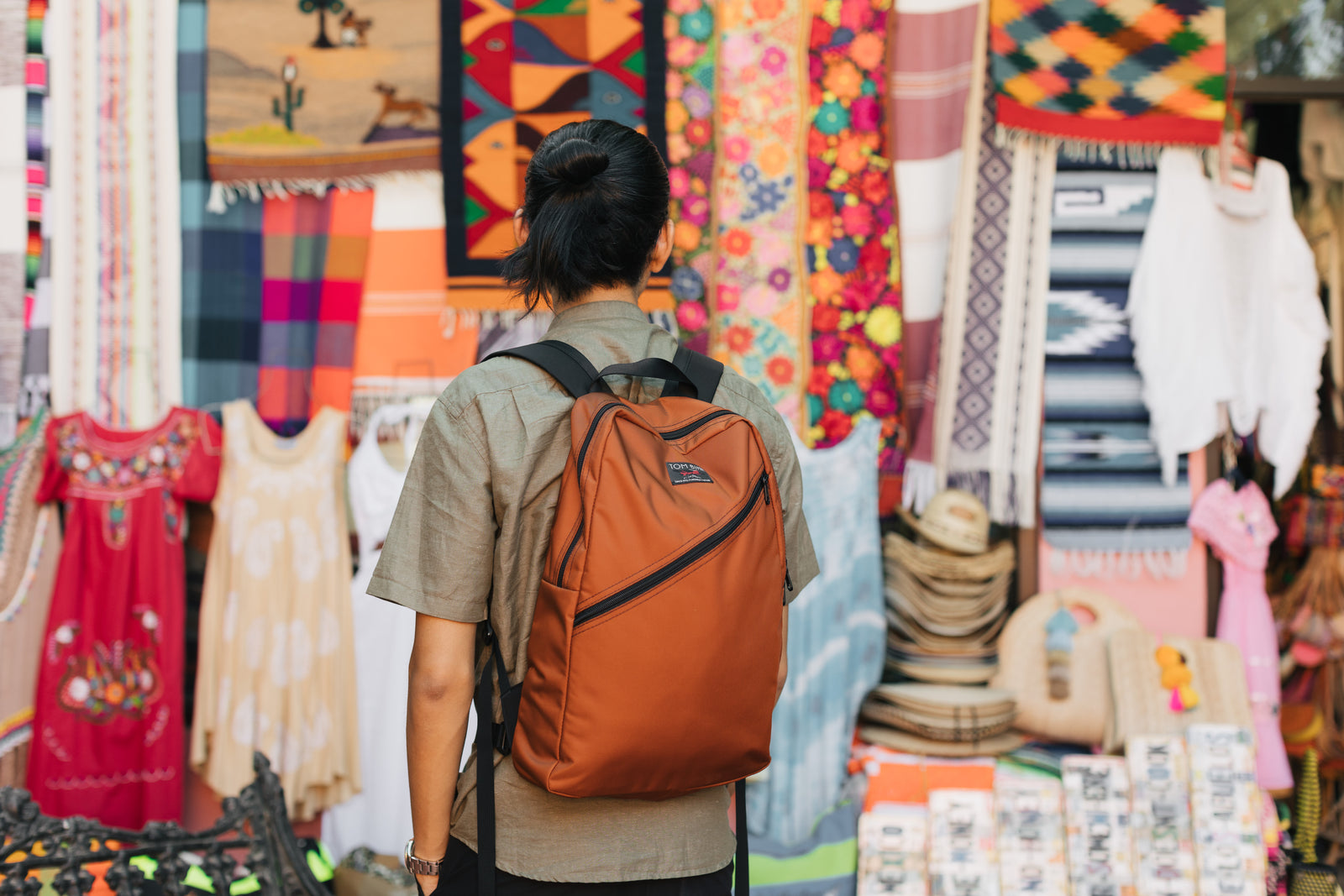 lifestyle visible^^A person wearing the Daylight Backpack while shopping.