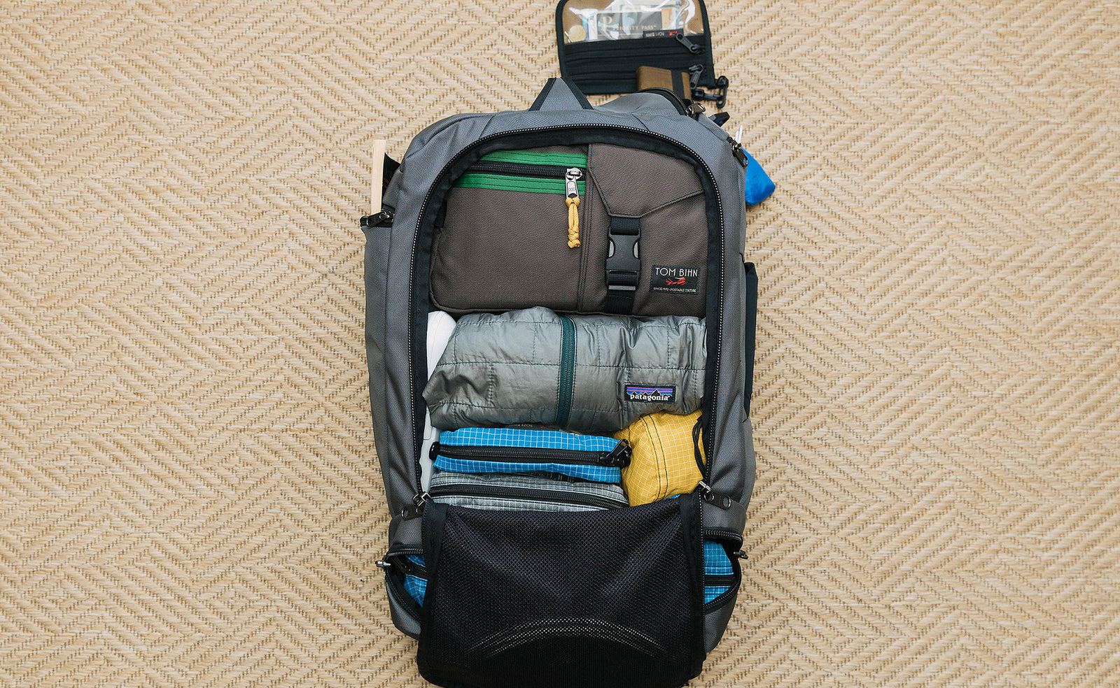 A potential load out of the Techonaut 45, including a LGD Waist Pack, packing cubes, a puffy jacket, and stuff sacks.