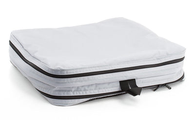 visible variant TB90605-NE^^An empty and zipped closed Northwest Sky (light grey) Aether Large Laundry Aeronaut 45 Packing Cube all-fabric side up.