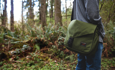 lifestyle visible^^A person carrying a Maker's Bag in the woods.