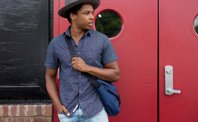 ^A person wearing the Medium Cafe Bag as a crossbody.