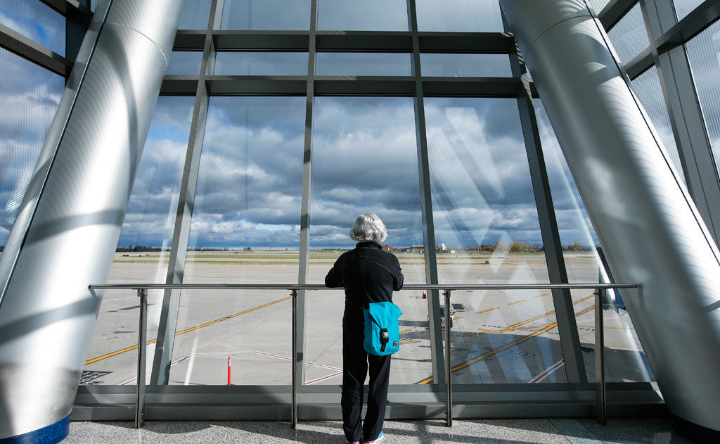 A person wearing a Medium Café Bag at an Airport