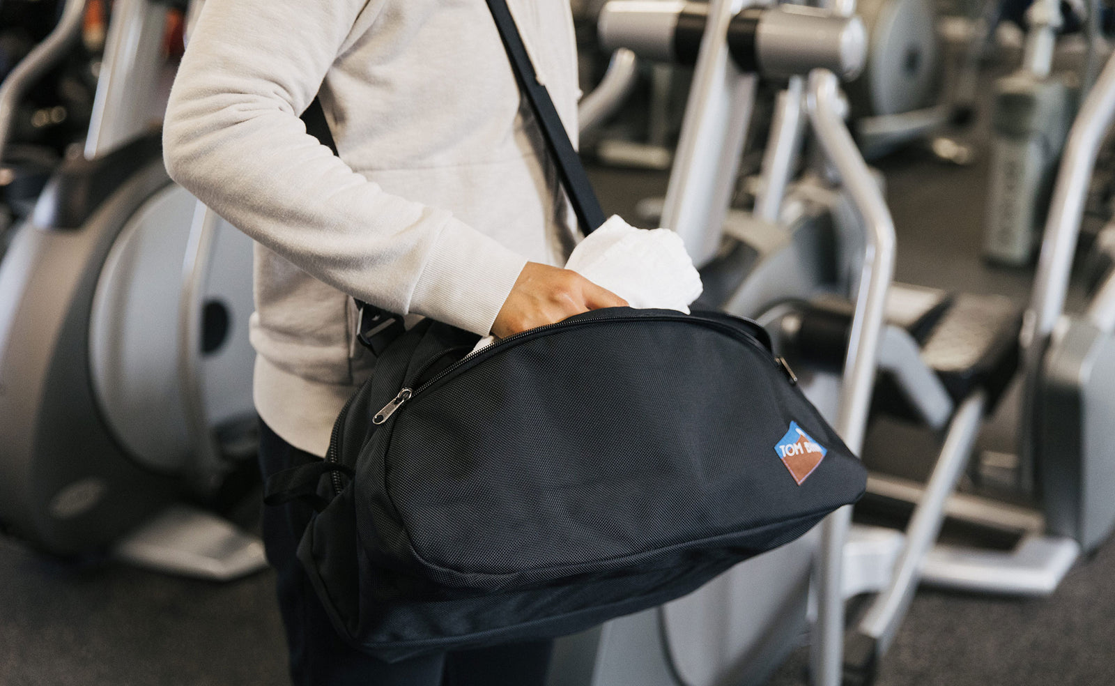 visible lifestyle^^Person carrying the OSCA in a gym with an optional shoulder strap.