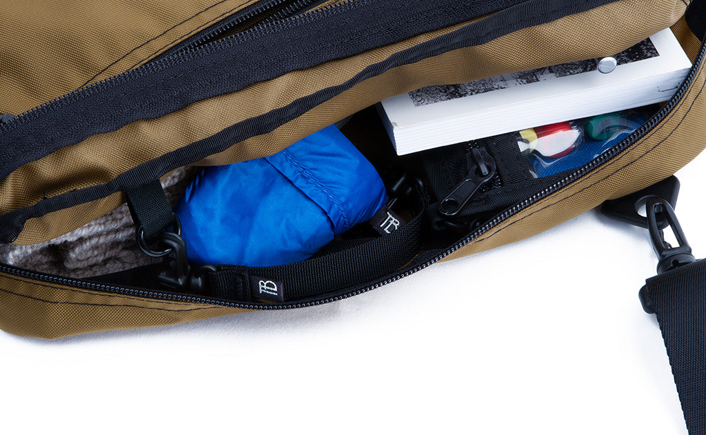 ^^A Packing Cube Shoulder Bag with a filled main compartment.