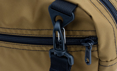 ^^A close shot of the Packing Cube Shoulder Bag's d-ring strap attachment point with a 1" shoulder strap attached.