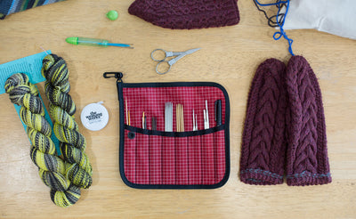 lifestyle visible^^A Pen Tool Wrap filled with knitting needles, thread rippers, a pen, and a fine-tipped Sharpie.