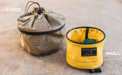 lifestyle detail visible^^A closed Large Travel Tray and an open Small Travel Tray.