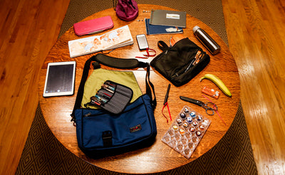 A Maker's Bag on a table with its contents arranged on the table.