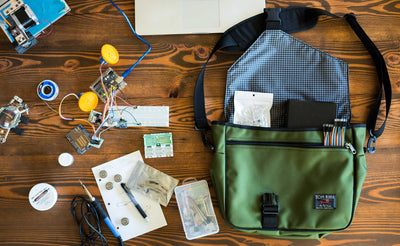 ^^A Maker's Bag on a table surrounded by breadboarding electronics..