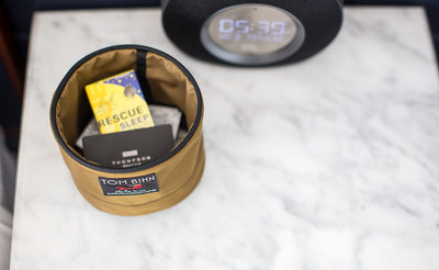 A Small Travel Tray containing a business card, tea packet, and wet wipe packet.
