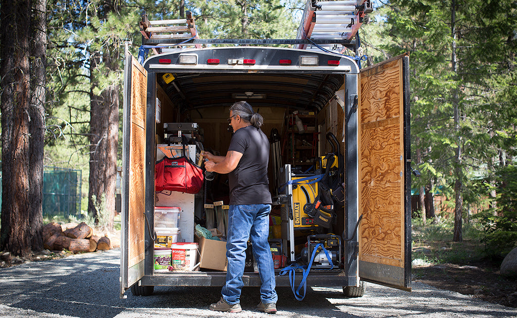 lifestyle visible^^The Truck in the trailer of a landscaping vehicle filled with tools.