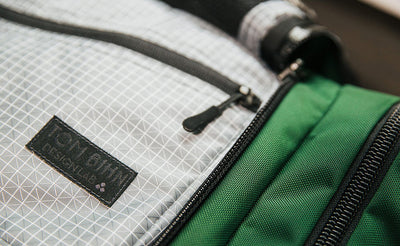 lifestyle visible^^Design Lab Edition Packing Cube Shoulder Bag being packed in an Aeronaut 45 travel bag.