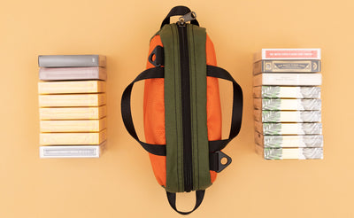 detail visible^^ A Texturized Orange Grab Bag with 17 decks of cards on either side.
