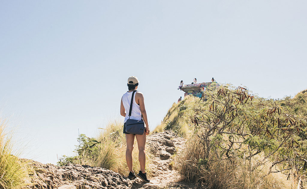 ^^A perosn hiking with a Packing Cube Shoulder Bag worn cross-body.