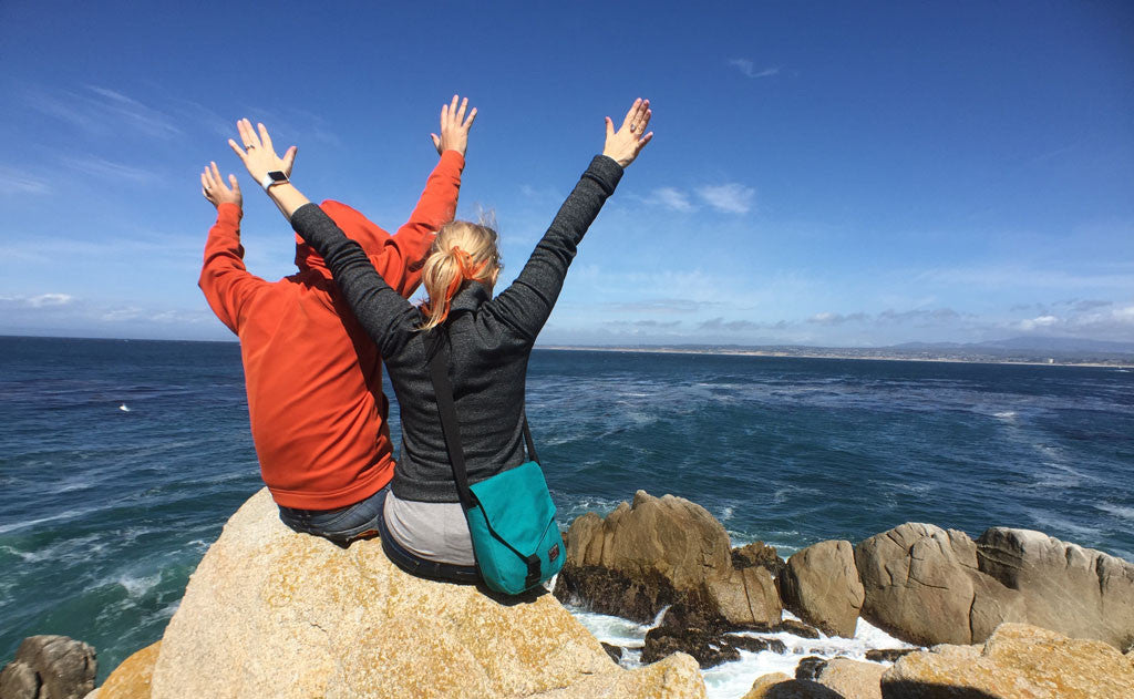 A person wearing the Medium Cafe Bag at the beach.