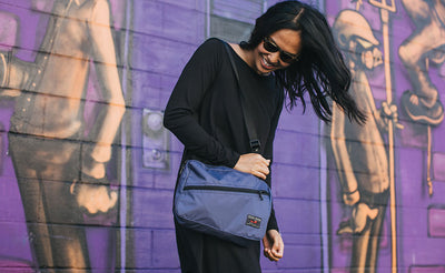 ^^A person carrying a Packing Cube Shoulder Bag as a shoulder bag.