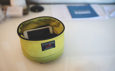 ^^A Small Travel Tray in Wasabi (green) 200 Halcyon holding an iPhone.