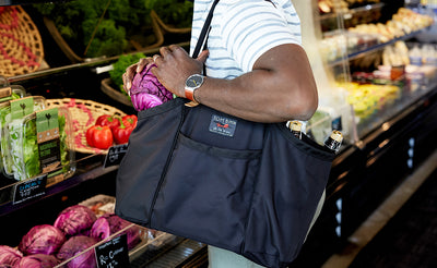 lifestyle visible^^A person carrying The Truck with the handles over their shoulder.