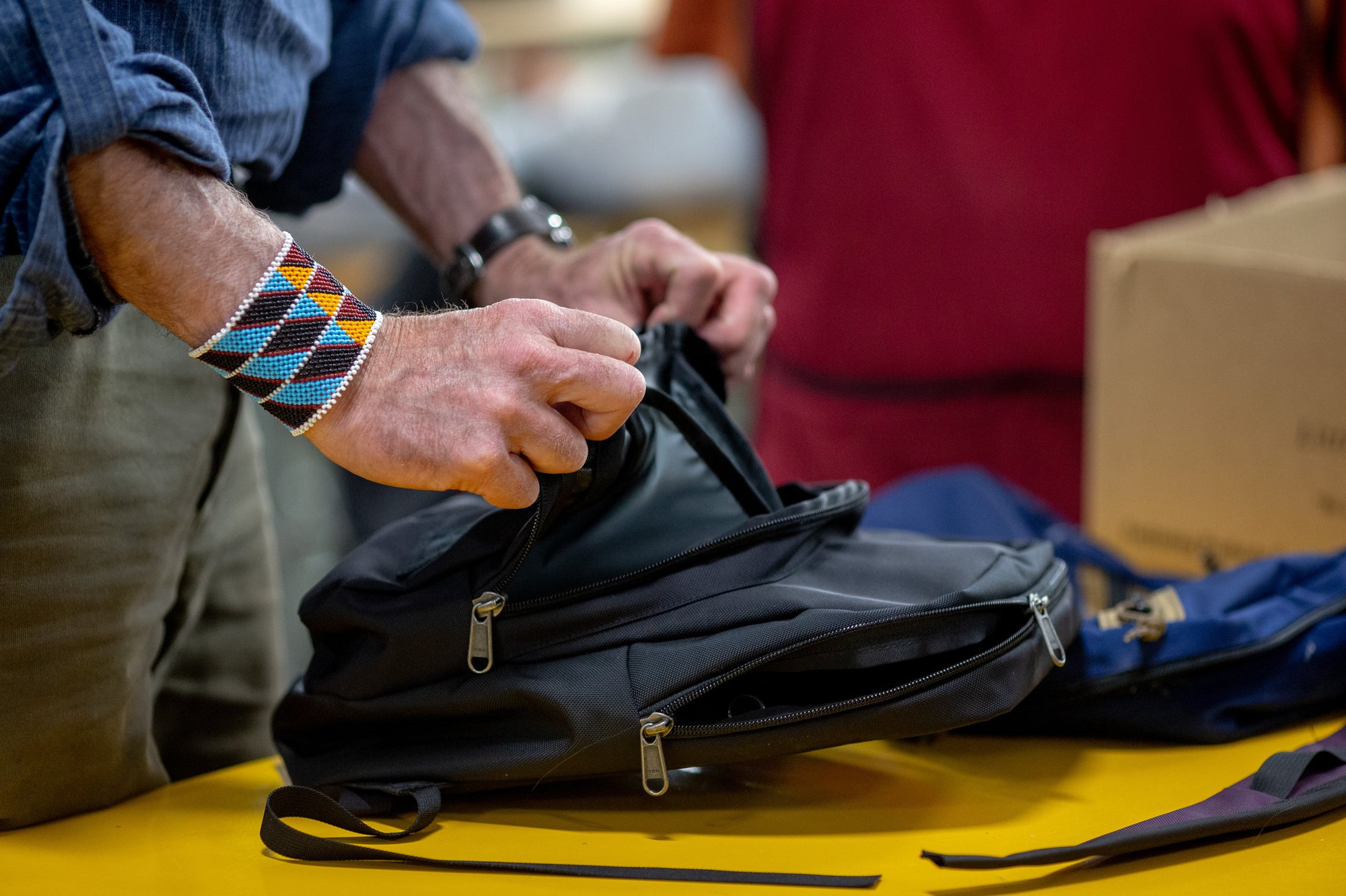 Tom inspects the front pockets on a Paradigm backpack.