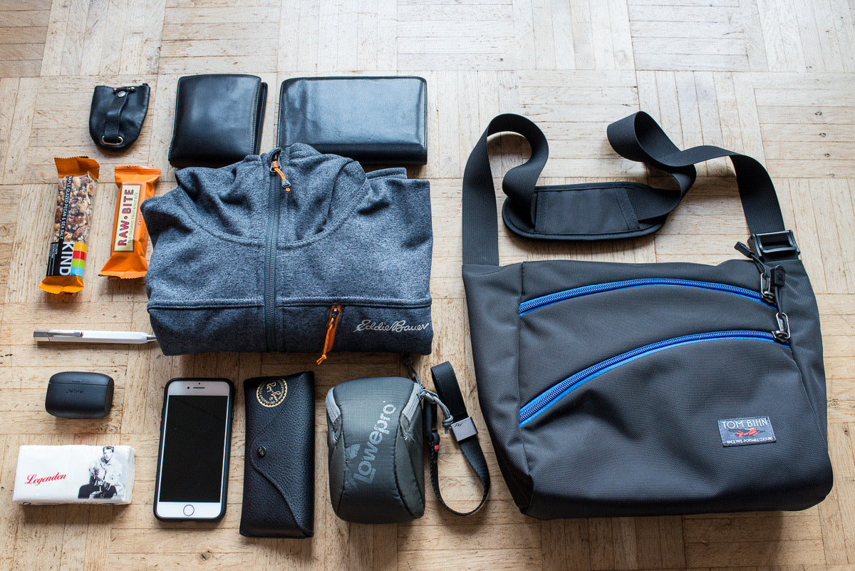 The Icon bag with a possible load out, including wallet, phone, keys, pens, protein bars, and a lightweight jacket.  
