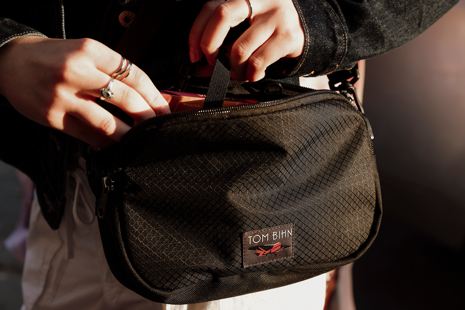 Person pulling key strap out of a 420D Spectron Big Bantam.