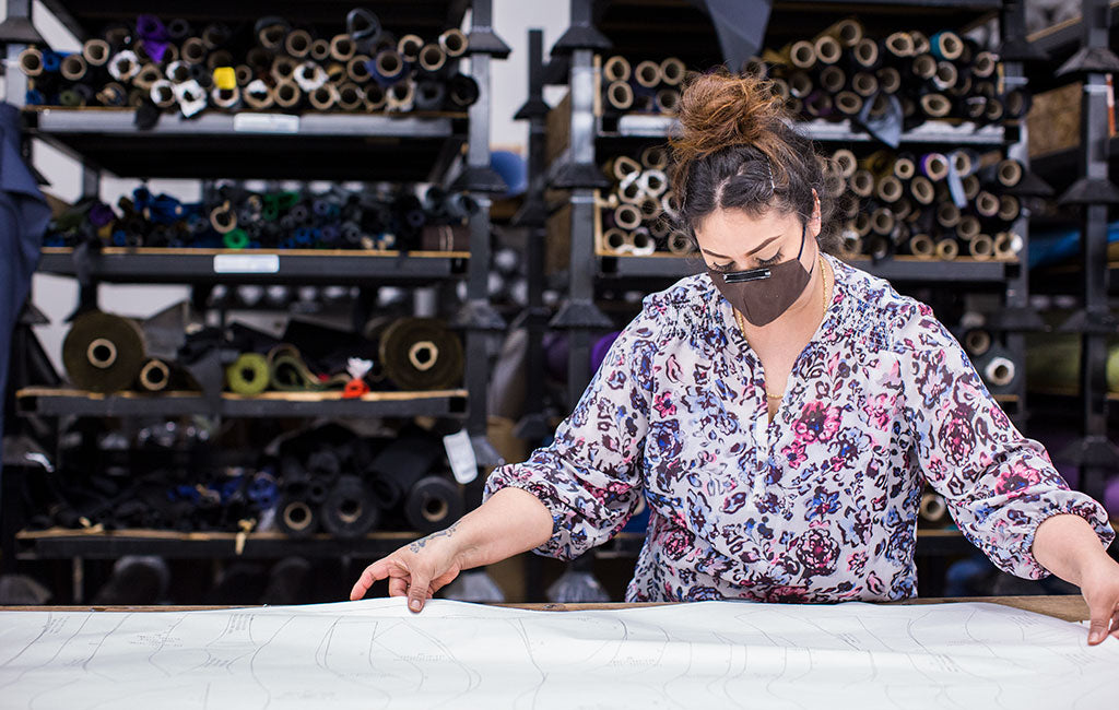 Irma laying out fabric to be cut.