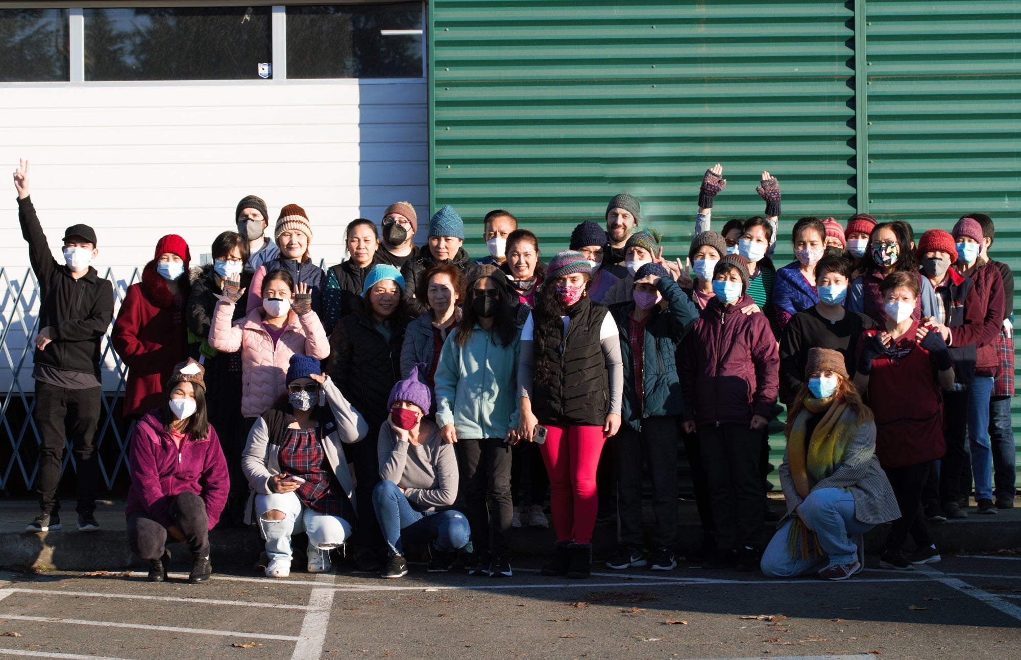 The team shows off their knitted goods from the TOM BIHN Ravelry group