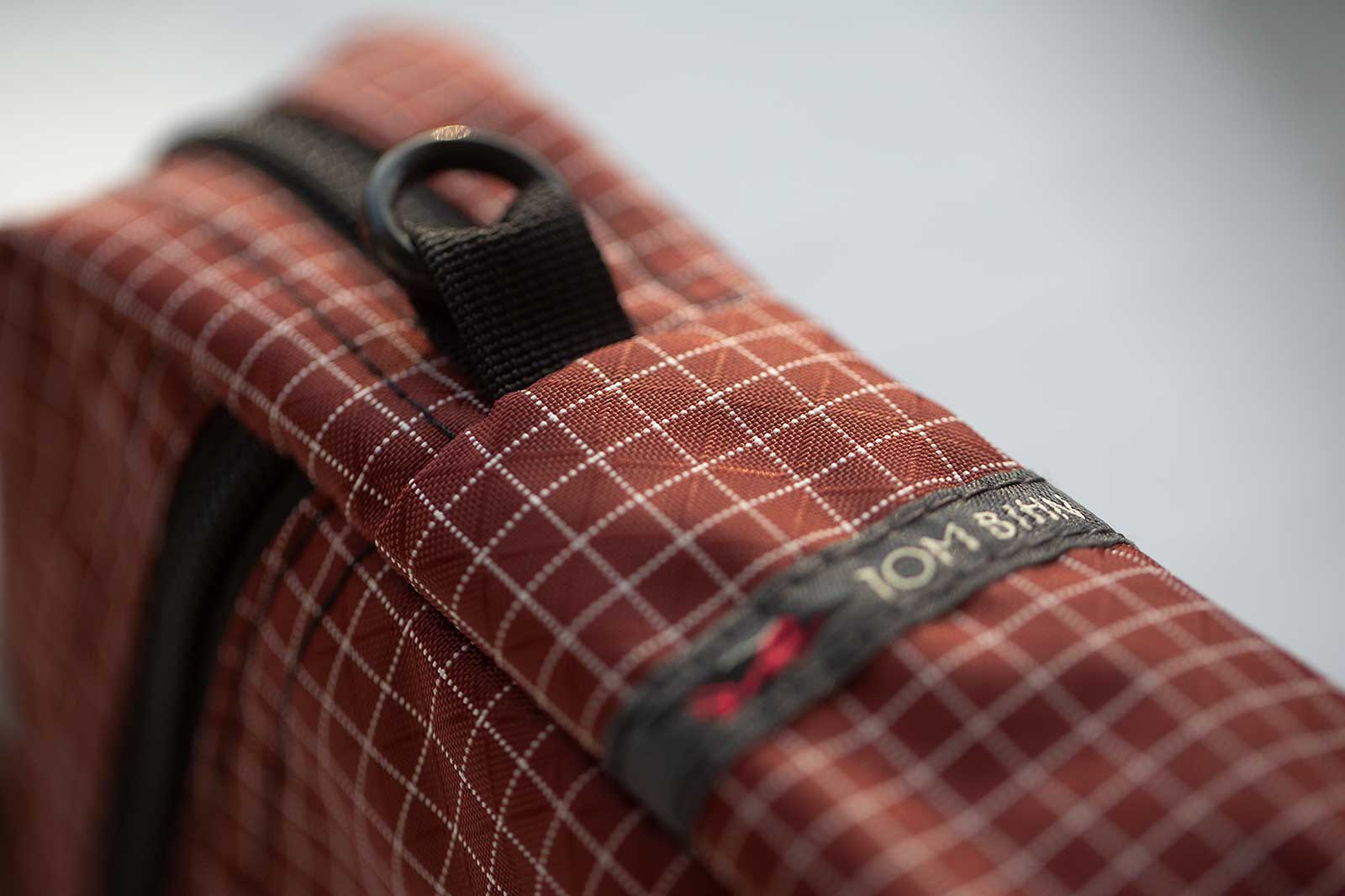 The Everyday Cubelet in Moab 200d Halcyon fabric, a deep reddish-brown color with a white grid pattern.