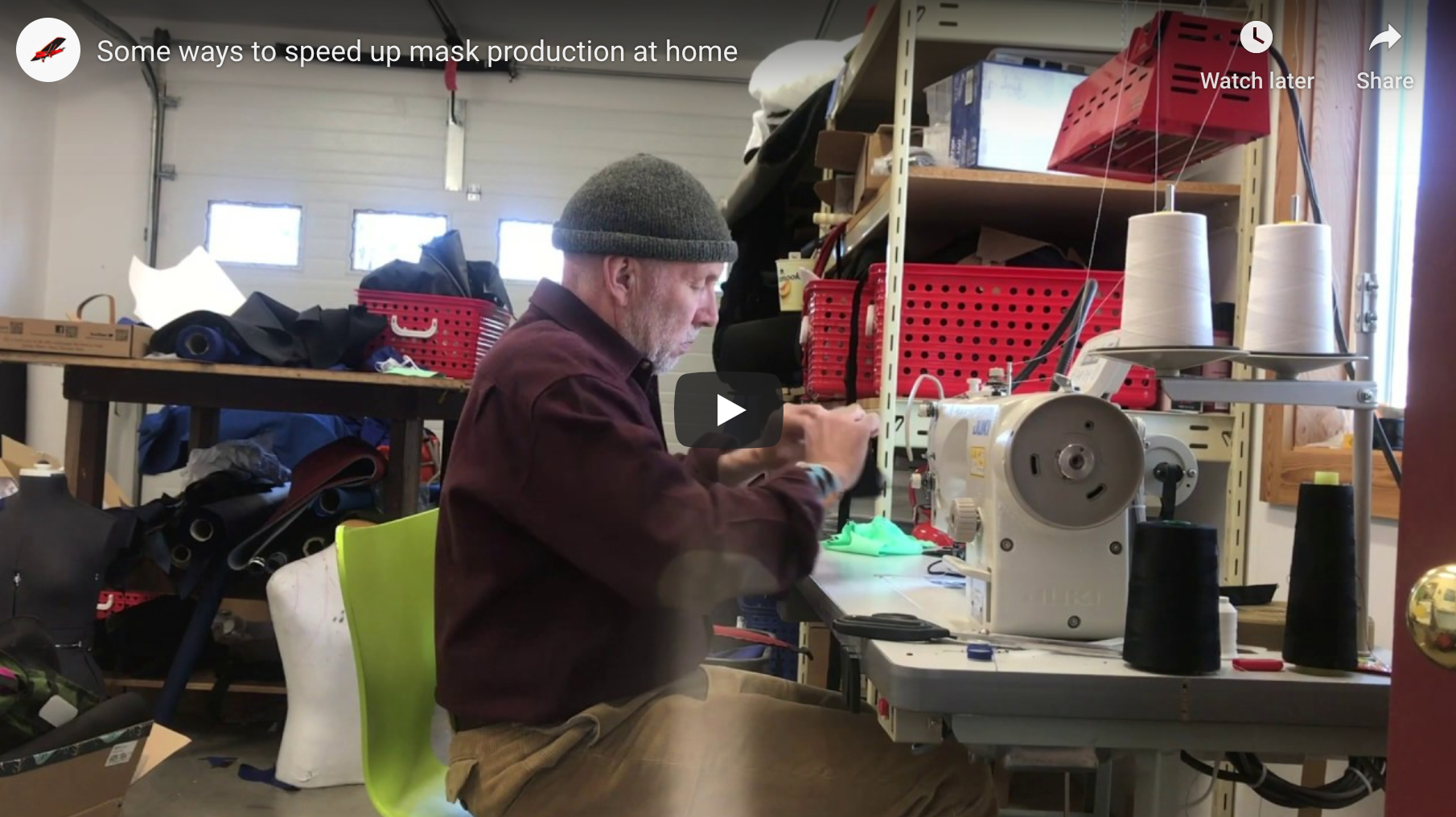 A person sitting at a sewing machine to sew masks.