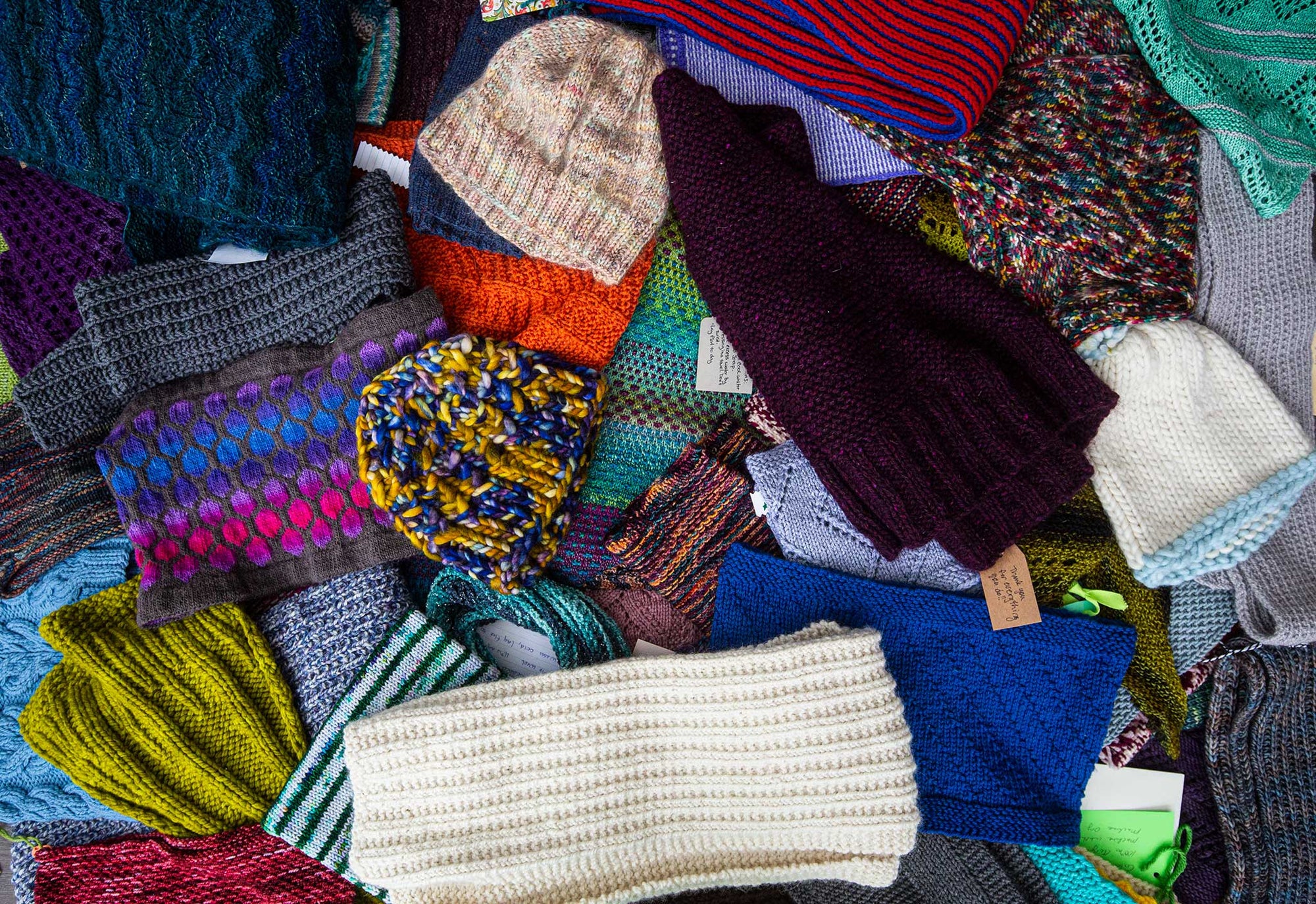 All of the various shawls, hats, scarves and cowls crafted for us in 2021 by the TOM BIHN Ravelry group.