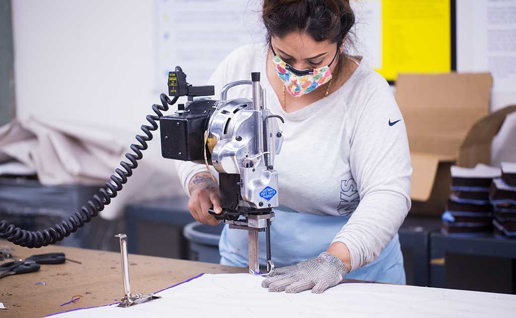 A person cutting material for making masks.