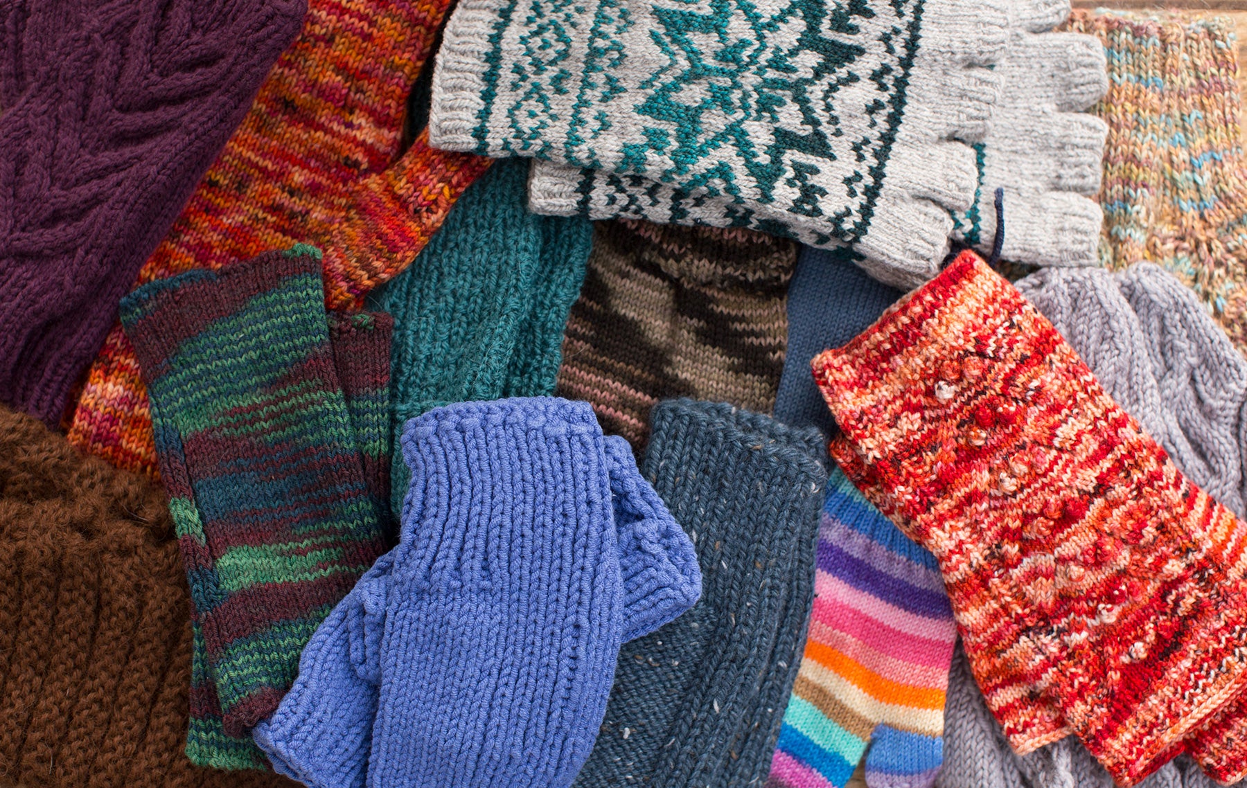A variety of knitted gloves sent to the TOM BIHN crew by the Ravelry knitting forum.