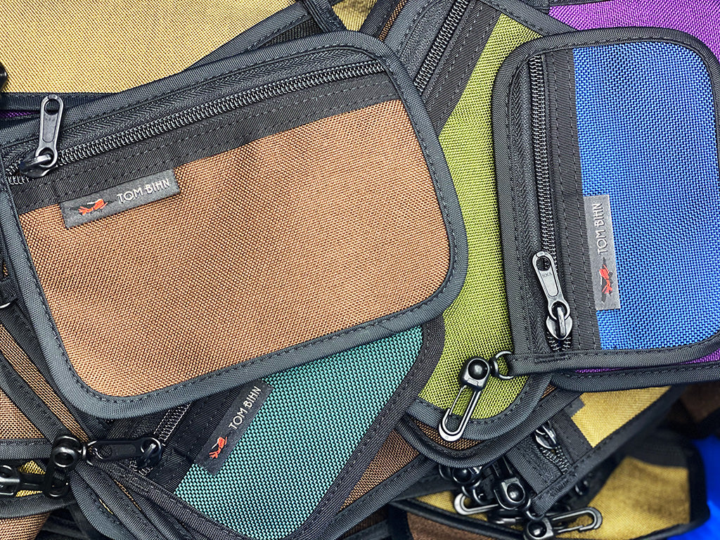 A pile of pouches of various sizes and colors.
