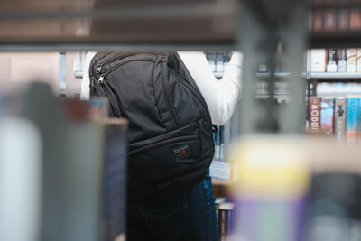 visible lifestyle^^A person wearing a Spectron Synik 26 in a library