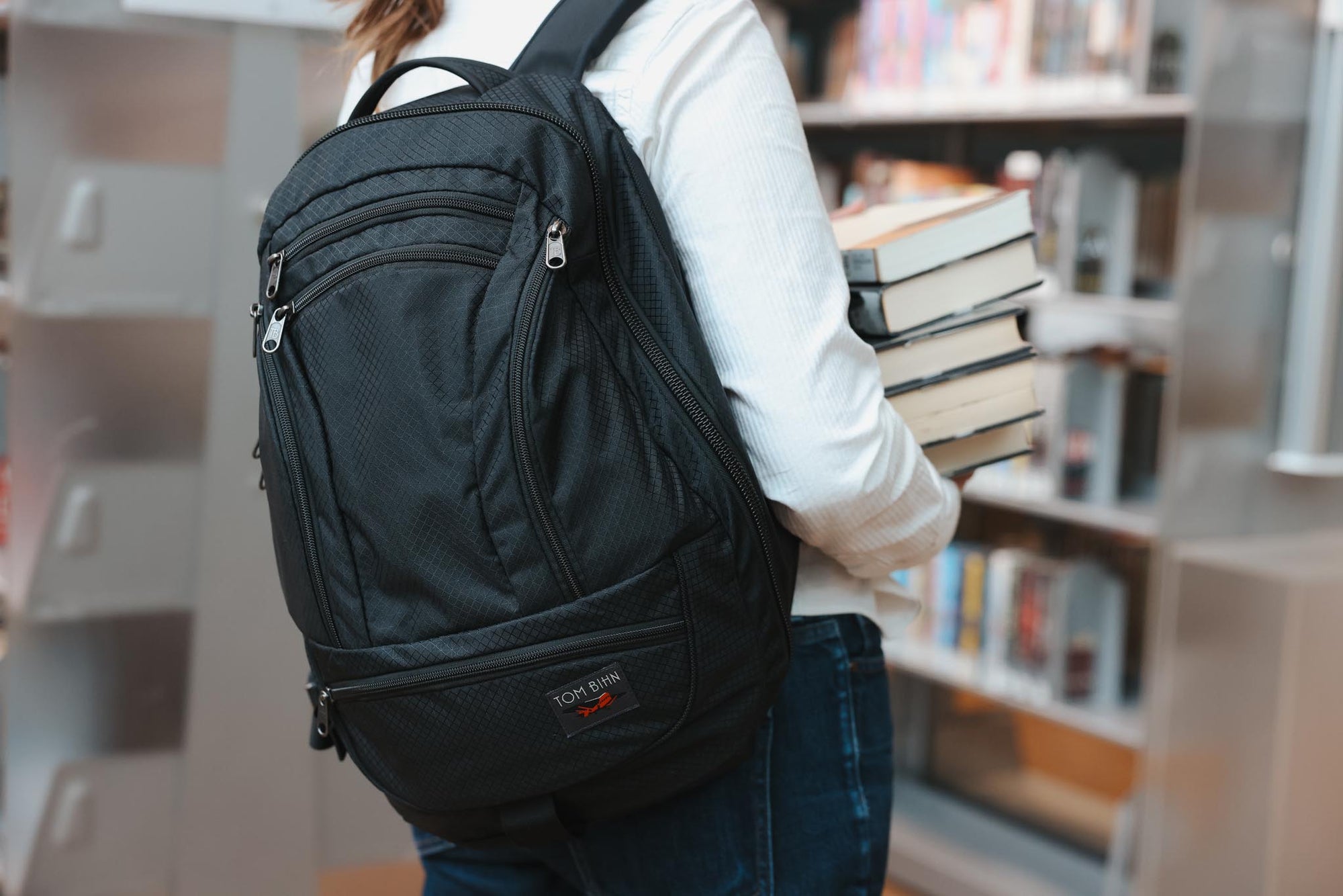 visible lifestyle^^A person wearing a Spectron Synik 26 in a library