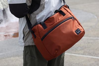 visible lifestyle^^A person carrying the Nomad 16 with a shoulder strap