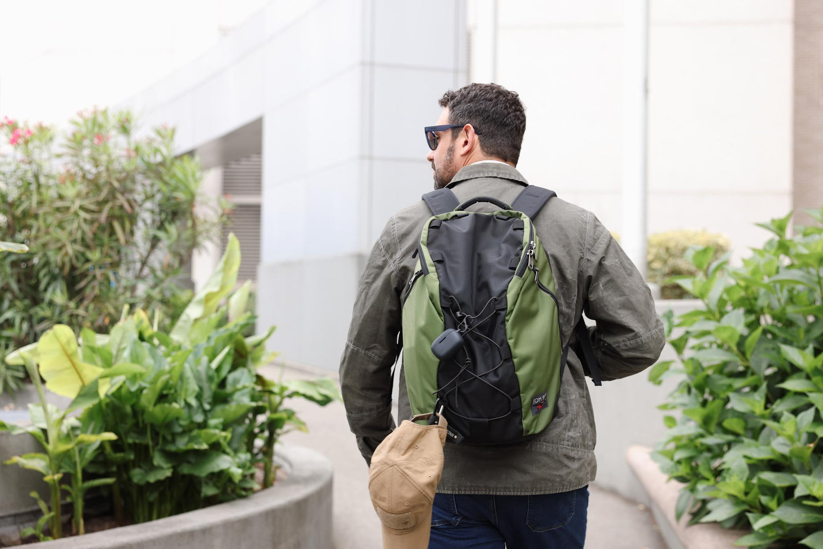 visible lifestyle^^A person carrying a Smart Alec 2.0 with a hat attached to the front.
