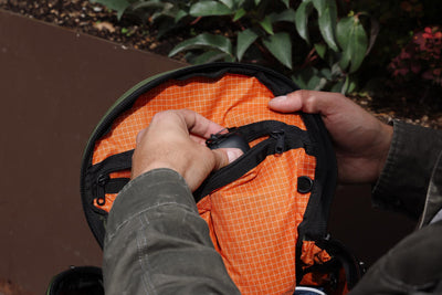visible detail^^A person accessing the top pocket in the main compartment of the Smart Alec 2.0