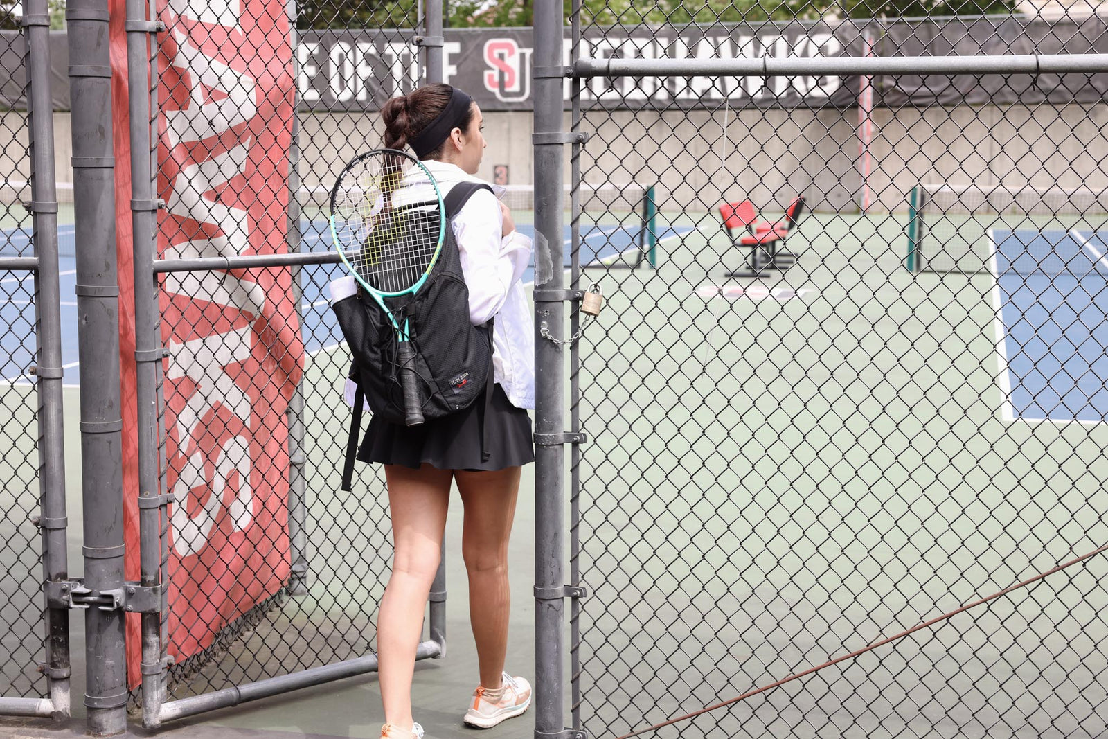 visible lifestyle^^A person carrying a Smart Alec 2.0 with a tennis racquet attached to the front.