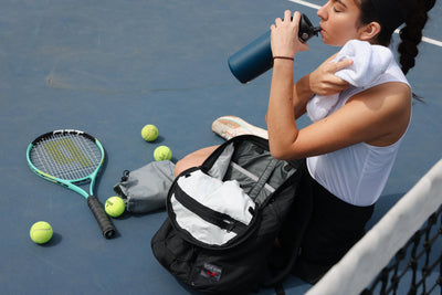visible lifestyle^^A person with their Smart Alec 2.0 at a tennis court.