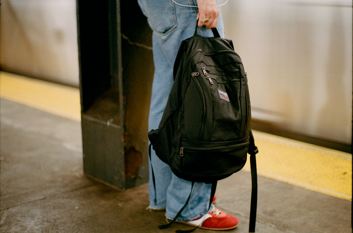 lifestyle visible^^Person holding Synapse 25 by a grab handle.