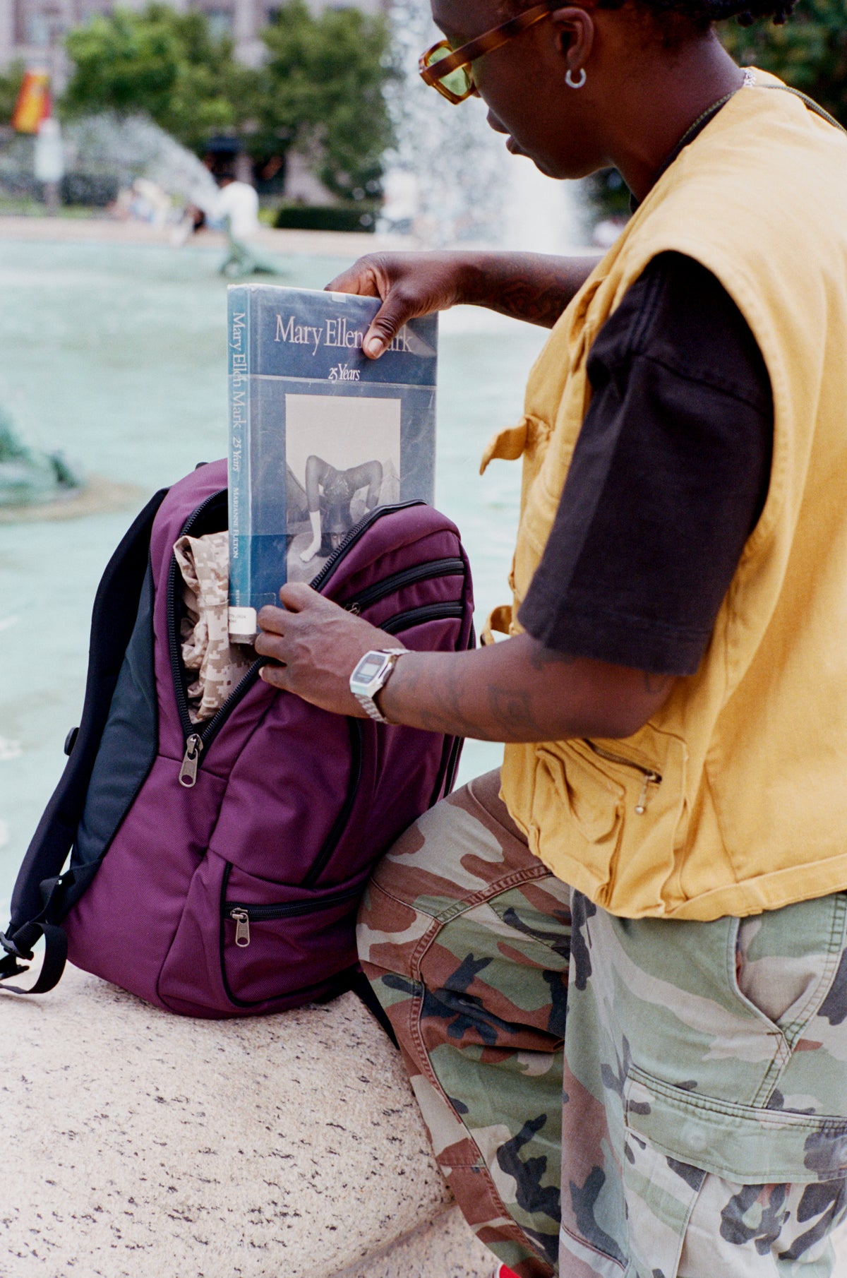 lifestyle visible^^Person putting a book into the main compartment of the Synapse 25.